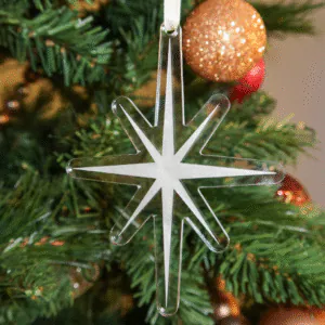 Clear star ornament with frosted engraved design on Christmas tree